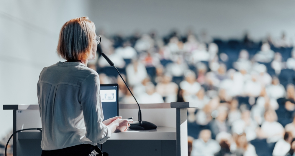 Female,Speaker,Giving,A,Talk,On,Corporate,Business,Conference.,Unrecognizable Female,Speaker,Giving,A,Talk,On,Corporate,Business,Conference.,Unrecognizable